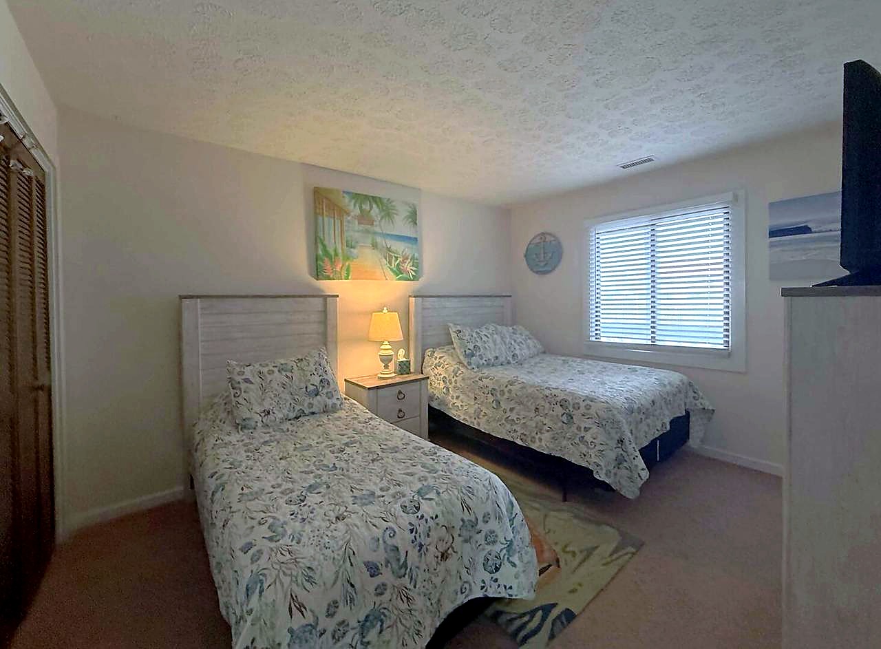Second bedroom with a queen bed and twin bed